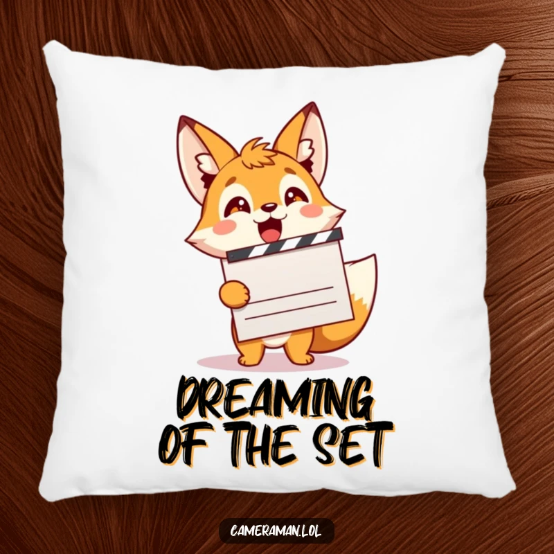 Funny, energetic fox sprite holding a clapperboard, looking excited, ideal for a comfortable pillow.